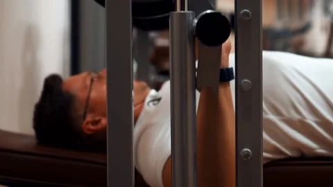 Man in the gym training with a barbell Stock Footage 142375302