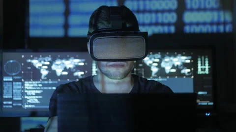 Man hacker programmer uses a virtual reality helmet for programming. IT Stock-Footage 87353751