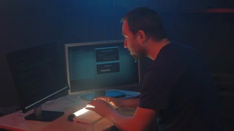 Man hacker smiles and shows the symbol fuck in the monitor display. Stock Footage 90979603