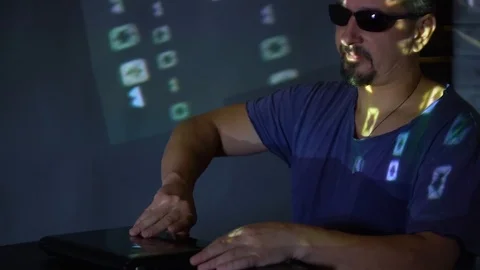 A man hacker in sunglasses in a dark room works with the program code. concept Vídeos de archivo 99163709