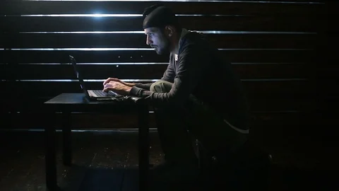 Man the hacker works behind the computer Stock Footage 90774680