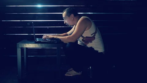 Man the hacker works behind the computer Video stock 94494106