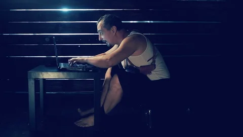 Man the hacker works behind the computer Video stock 94794250