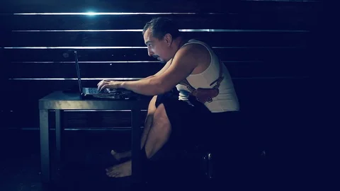 Man the hacker works behind the computer Video stock 95031504