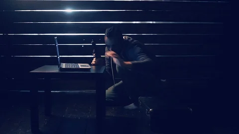 Man the hacker works behind the computer Video stock 97222401