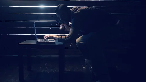 Man the hacker works behind the computer Stock Footage 97222955