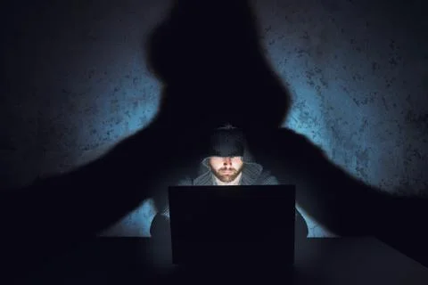 Man hacker works in dark empty room 스톡 사진