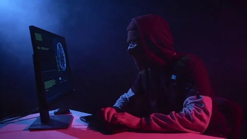Man hacking computer sitting in a dark room. Black smoke background Vídeos de archivo 80452332