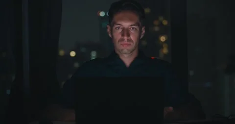 Man hacking in covert night setting, hacker deeply engaged in secret digital Stock Footage 312123571