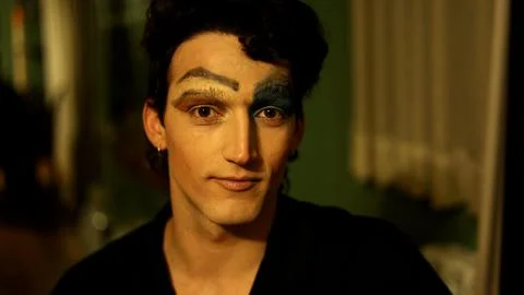 Man with half face makeup looking at the camera indoors Stock Photos