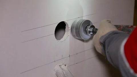 Man with Hammer drill doing hole for socket Stock Footage 69862631
