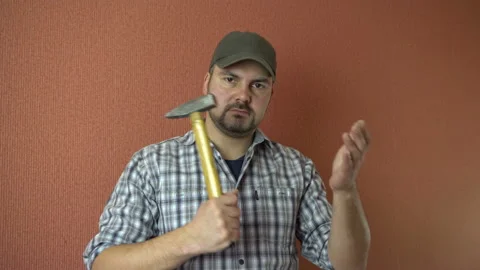 The man with the hammer in hand 4K Stock Footage 87803470