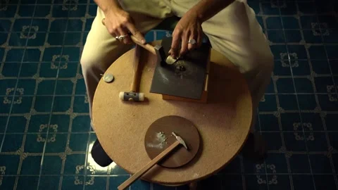 Man hammering brass sheet in goldsmith workshop. Stock Footage 253390241