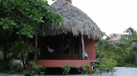 Man in a Hammock Outside Hut Stock Footage 46039064