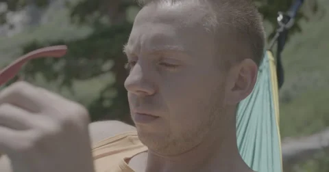 Man in hammock with sunglasses Stock Footage 65199322