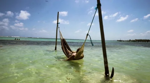 Man on hammock in the water Stock Footage 47784691