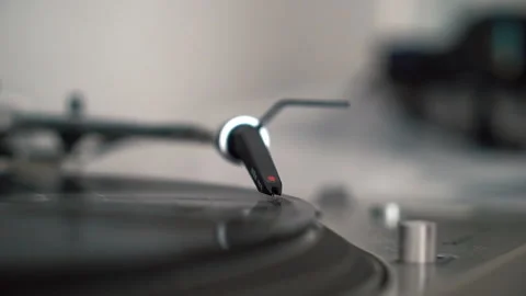 Man hand adjusts the head old record player and vinyl discs at home. Stock Footage 211154076