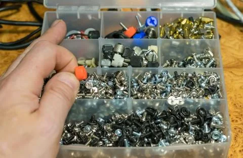 Man hand and a set of different bolts Stock Photos