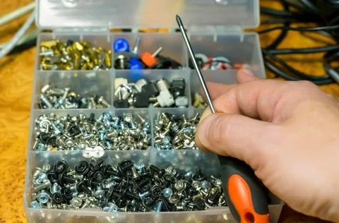 Man hand and a set of different bolts Stock Photos