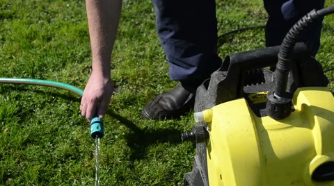 Man hand attach water hose to high pressure wash equipment Stock Footage 41345500
