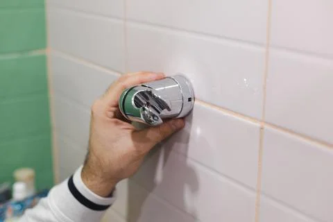 Man hand attaching and installing shower head holder with crosshead screwdriver Stock Photos
