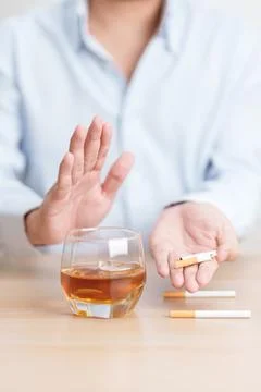 Man hand break and stop gesture to refuse cigarette and glass of Whisky, fo.. Stock Photos
