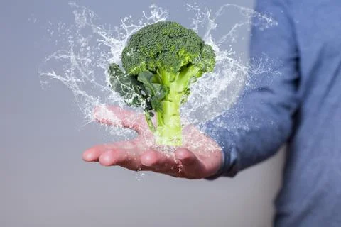 Man Hand Broccoli Water Splashes Stock Photos