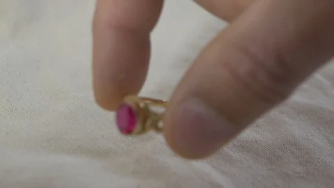 Man hand builds a stack of real gold rings Stock Footage 114683520