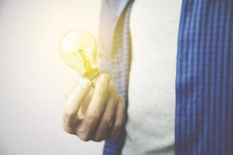 Man hand bulb Stock Photos