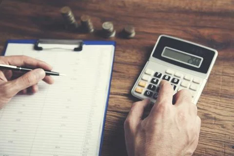 Man hand calculator and document on table Stock Photos