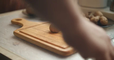 Man hand carefully cut wild mushrooms on a kitchen wooden board Stock Footage 87861379