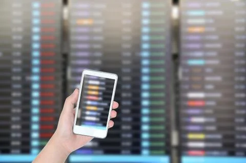 Man hand checking flight with flight board with smart phone, Technology conce Stock Photos