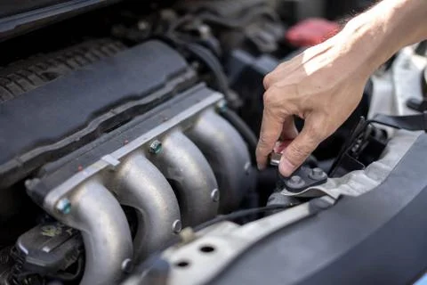 Man hand checking level of coolant car engine. Service and maintenance car or Stock-Fotos