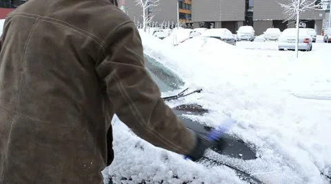 Man hand clean remove snow car windshield window brush winter Stock Footage 22111922