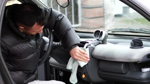 Man hand cleaning smart car interior dashboard, air vent Stock Footage 326070576