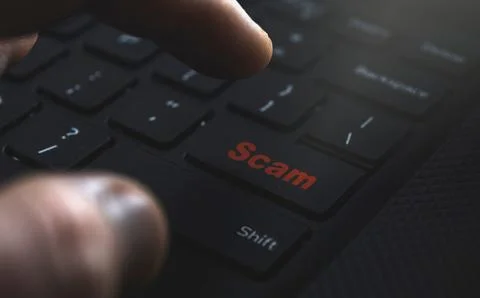 Man hand click Scam button on keyboard. Scam online concept on internet Stock Photos