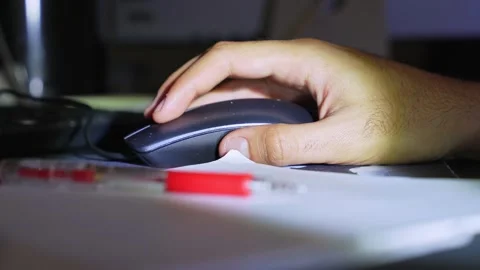 Man hand clicking computer mouse at night Stock Footage 334092236