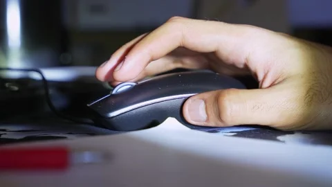 Man hand clicking computer mouse at night Stock Footage 334092421