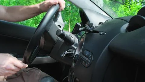 Man hand close-up making steering wheel rotation driving on turn. Close up Stock Photos