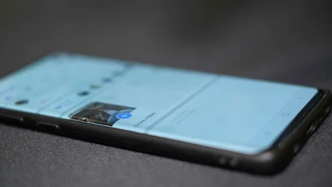 Man hand close up while tapping on Facebook app icon on a smartphone,social tech Stock Footage 143957363