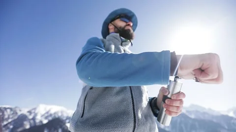 Man with hand coffee grinder in the winter mountains Stock Footage 171001002