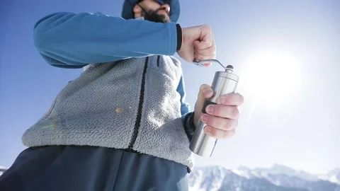 Man with hand coffee grinder in the winter mountains Stock Footage 171001104