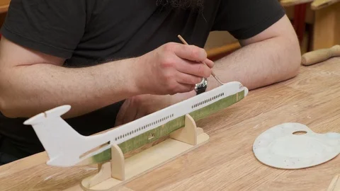 Man hand colours outdated jetliner model fuselage edge Video stock 127375847