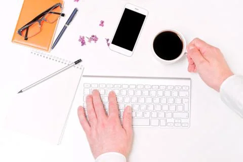Man hand computer keyboard coffee workplace notebook mobile phone lilac Stock Photos
