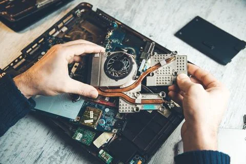 Man hand computer processor with fan on the table Stock Photos