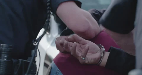 Man In Hand Cuffs Resisting Arrest By Two Police Officers, Cops, Under Arrest. Stock Footage 165951364
