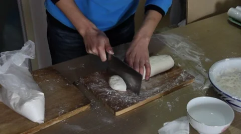 Man hand cutting dough to make steamed buns Stock Footage 47696972