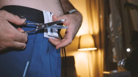 Man hand cutting scissors from new sport running shorts Stock Footage 111536355