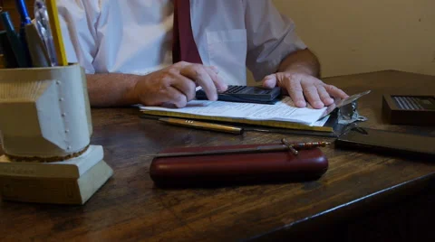 Man with hand digital calculator in his office desk Stock Footage 56740145