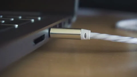 Man hand disconecting headphones cable, audio jack insert. Close up shot Stock Footage 87377374